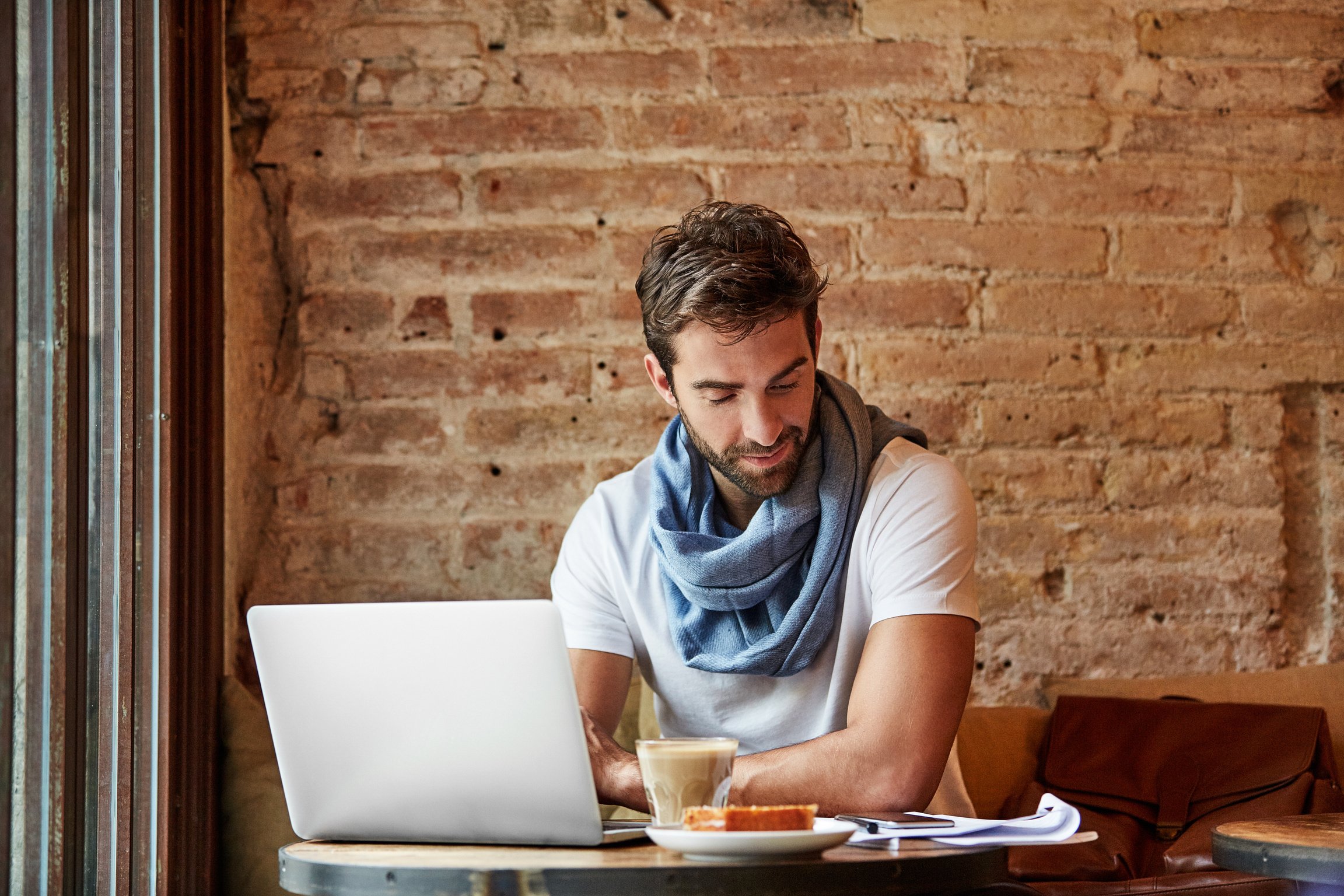 Sending out his resume from the nearest cafe